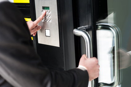 Man entering security code to unlock the door